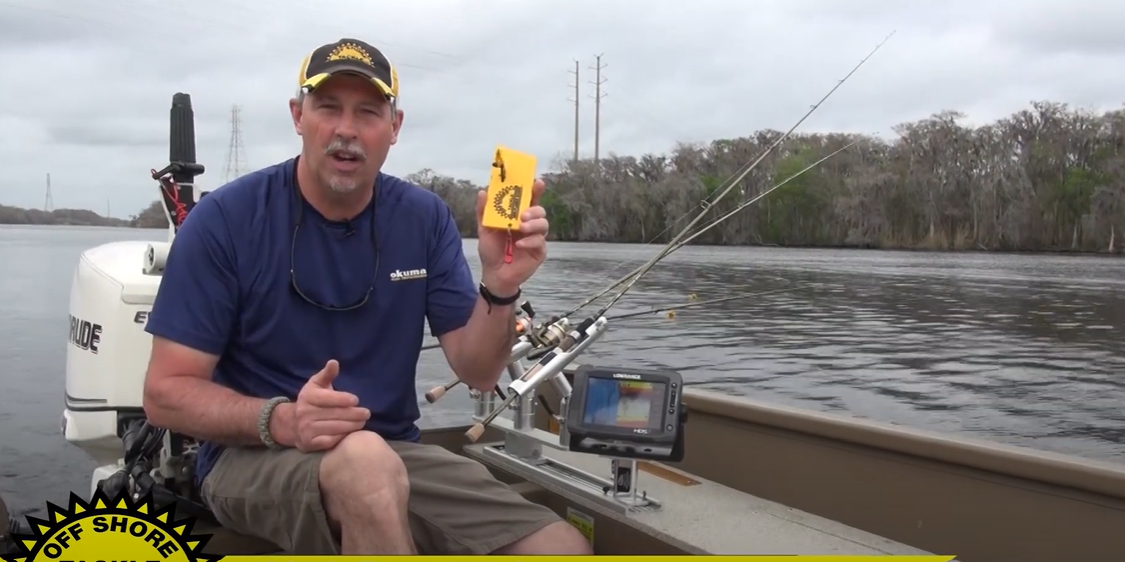 Video: an angler in a boat holds an OR34 Mini Planer Board for crappie fishing